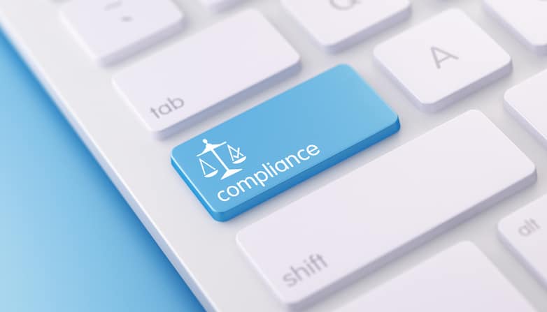 Keyboard with a compliance button, representing SEC cybersecurity enforcement and IT controls for RIAs.