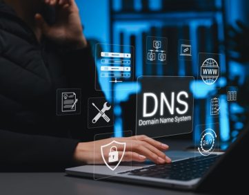 Person using a laptop in a server room with digital DNS, web, security, and network icons overlaid.