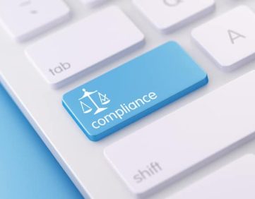 Keyboard with a compliance button, representing SEC cybersecurity enforcement and IT controls for RIAs.