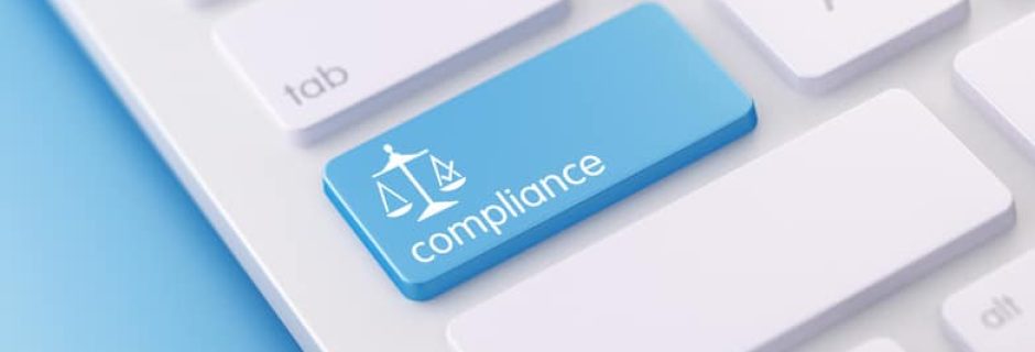 Keyboard with a compliance button, representing SEC cybersecurity enforcement and IT controls for RIAs.