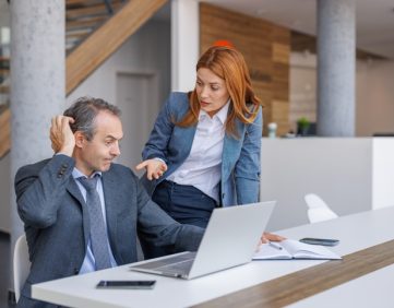 Financial advisory professionals reviewing technology issues and IT support solutions during a Microsoft 365 modernization project.